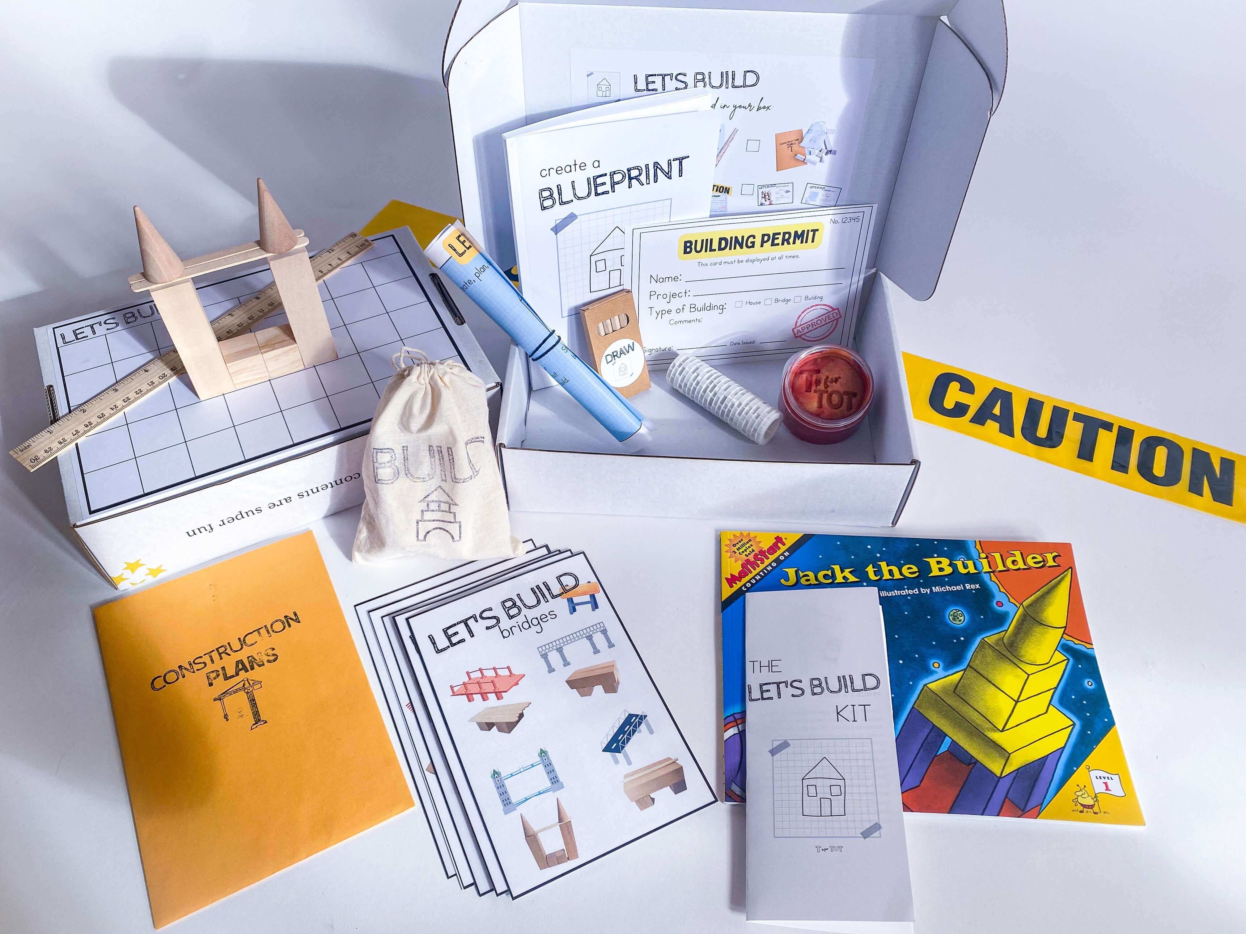 Construction play kit for kids with homemade non-toxic playdough, brick playdough roller, and building blocks. Features construction plans for educational play, role play items like blueprint and caution tape, and a blueprint journal with colored pencils and ruler.